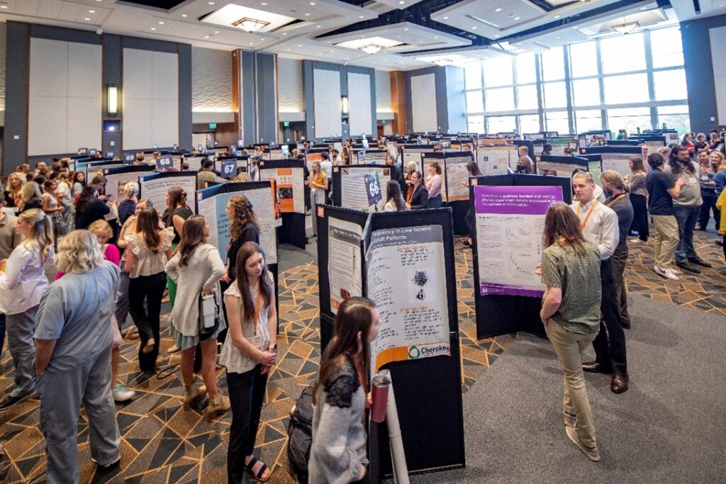 Students presenting poster sessions at conference.